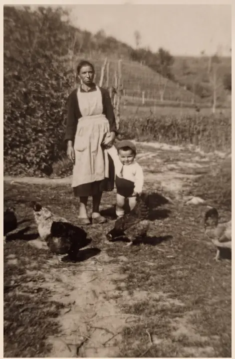 A photograph from the family collection, undated and unidentified. In the background, the hillside planted in terraces.