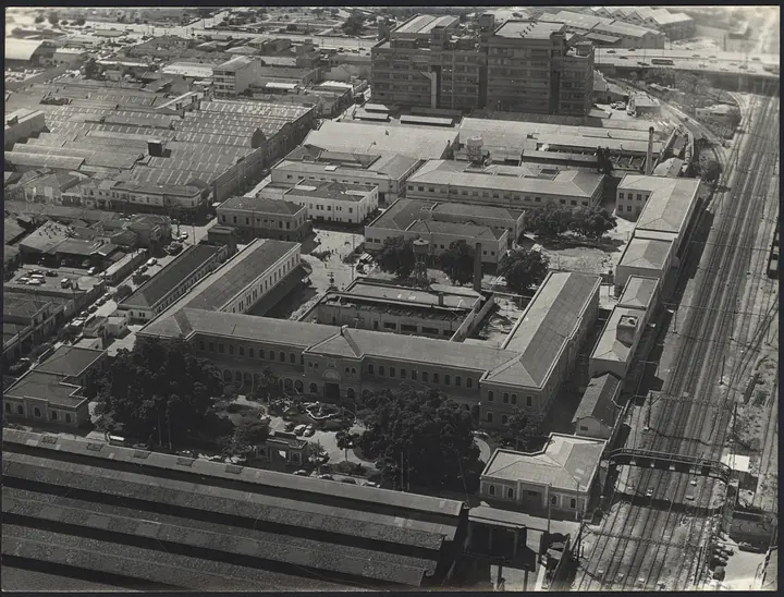 The Hospedaria dos Imigrantes do Brás from above, with the tracks running into the grounds: immigrants stepped off the train already inside the wall.