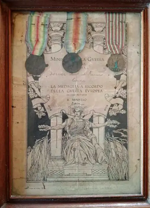 The frame holding Sante Forner’s three war medals, on the wall of the family home in the Veneto. On the certificate, handwritten: Forner Sante di Vincenzo.